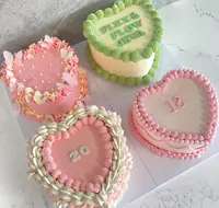 Four heart and round vintage cakes in pink, cream and green